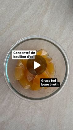 a glass bowl filled with oranges on top of a table