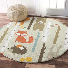 a round rug with animals and trees on it in front of a white door, next to a window