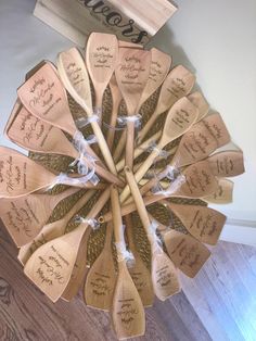 many wooden spoons with writing on them are arranged in a circular arrangement and tied together