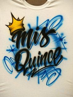 a white shirt with blue spray paint and a crown on it