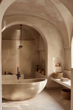 a bath room with a large tub and a sink in it's center area