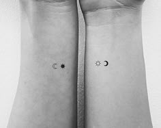 two matching wrist tattoos with the moon and stars on each one's sides,