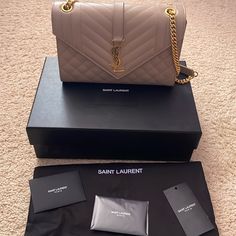 Authentic Ysl Triquilt Medium Shoulder Bag In Dark Beige. Gorgeous Bag This Includes The Ysl Box, Dust Bag, And Receipt. Can Be Worn As A Shoulder Bag Or Crossbody. Retails For $2950. Timeless Envelope Flap Bag In Grain De Poudre Embossed Leather, Featuring Chevron And Diamond Quilt Overstitching. Versatile Bag With An Adjustable Sliding Chain. Chrome And Metal-Free Tanned Leather Grosgrain Lining Light Bronze Brass Hardware One Exterior Back Pocket Magnetic Snap Tab One Interior Slot Pocket Dim Ysl Box, Line Light, Dark Beige, Diamond Quilt, Flap Bag, Brass Hardware, Embossed Leather, Yves Saint Laurent, Calf Skin