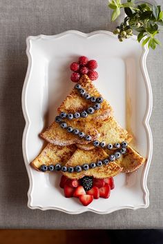 french toast with berries and blueberries in the shape of a christmas tree