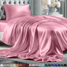 a bed covered in pink sheets and pillows