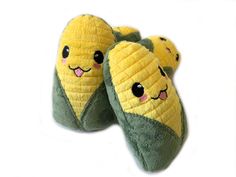 two slippers that have been made to look like corn on the cob with faces