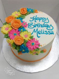 a birthday cake decorated with flowers and the words happy birthday melissa