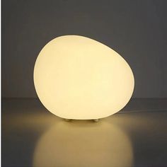 an egg shaped light sitting on top of a table