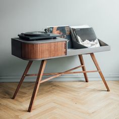 a record player sitting on top of a wooden table