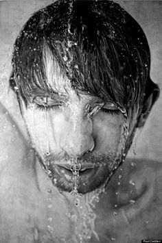 a black and white photo of a man's face with water coming out of his eyes