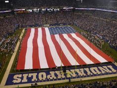 an american flag is displayed on the field