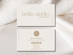 two white business cards with gold foil on them