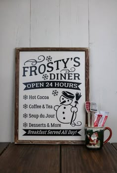 a sign that says frosty's diner open 24 hours next to a coffee mug