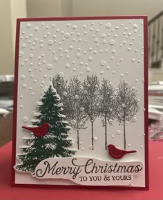 a christmas card with two birds on it