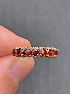 VINTAGE 7 stone Rich Red Genuine Garnet Ring 9k Yellow gold Size 7.5 and easily sizable within reason Makers hallmark inside + 375 and others = 9k gold  7 garnets faceted about 3.25mm prong set 1.7grams Excellent condition! GARNET is a stone of regeneration and energizing it can boost energy. It is said to be stabilizing in that it can bring order to chaos whether internal or external. Antique box for display only. FREE SHIPPING Vintage Garnet Ring With Center Stone, Victorian Style Red 14k Gold Ring, Victorian Garnet Ring, Victorian Garnet Gemstone Rings, Victorian Multi-stone Ruby Ring, Alternative Wedding Bands, Red Stone Ring, Garnet Ring, Antique Boxes