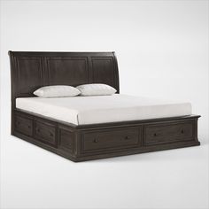 a bed with two drawers underneath it on a white surface, and the headboard is made from wood