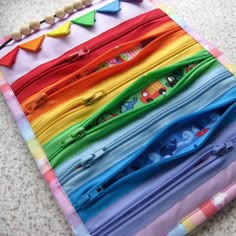 there are many colorful zippers on the table top, all lined up and ready to be sewn