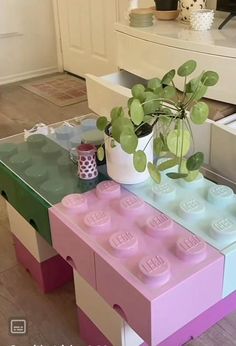 a table with legos on it and a potted plant sitting on top of it