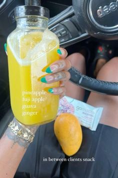 a woman is holding up a drink in her hand with the words pineapple fun apple guava ginger on it