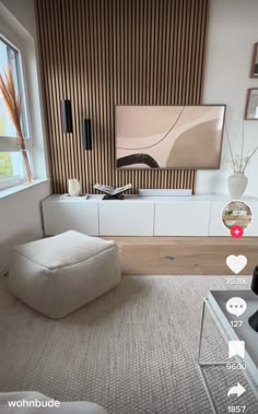 a modern living room with white furniture and striped wallpaper