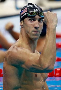 a man standing in the water with his arm up