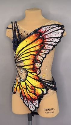 a mannequin with a yellow and black butterfly on it's back side