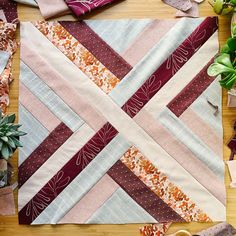 a table topped with lots of different types of quilts