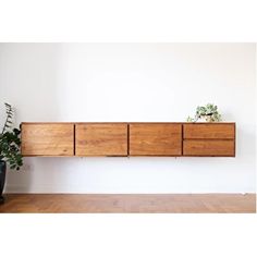 a wooden shelf with plants on top of it