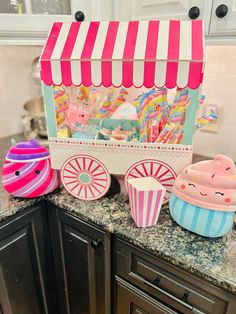 an ice cream cart and cupcakes are on the counter