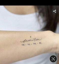 a woman with a tattoo on her arm that reads, family and date in cursive writing