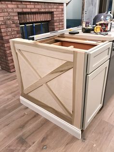 an unfinished kitchen cabinet in the process of being built with woodworking tools and supplies