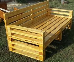 a wooden bench sitting on top of a lush green field