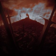 the silhouette of a person standing on top of a hill with three crosses in front of them