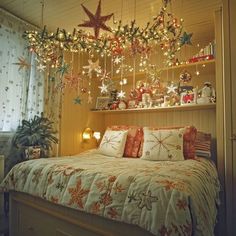 a bedroom decorated for christmas with lights and decorations hanging from the ceiling above the bed