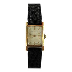 Elegant vintage Tiffany & Co. manual wind dress watch made with 18-karat yellow gold. It is slender and has a soft rectangular design. Art Deco Rectangular Watch With Diamond Hour Markers, Art Deco Rectangular Watch With Diamond Markers, Yellow Gold Business Watch With Rectangular Shape, Yellow Gold Business Watches With Rectangular Shape, Elegant Gold Square-faced Watch, Elegant Gold Square Face Watch, Vintage Yellow Gold Rectangular Watch, Vintage Rectangular Yellow Gold Watch, Timeless Yellow Gold Rectangular Watch