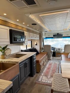 a kitchen and living room inside of a motorhome with an open floor plan