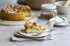 a piece of pie sitting on top of a white plate next to a bowl and spoon