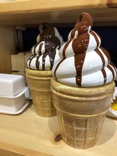 three ice cream sundaes sitting on top of a counter