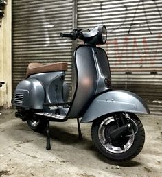 a motor scooter parked in front of a garage door