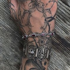 a person with tattoos on their arm and wrist