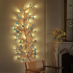 a living room filled with furniture and a wall mounted light fixture covered in blue flowers