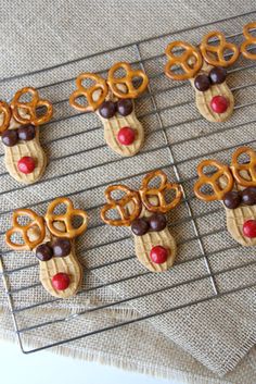 some pretzels are decorated like reindeers and rudolph's nose is sticking out of them