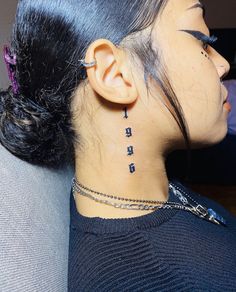 a woman with tattoos on her neck and behind the ear