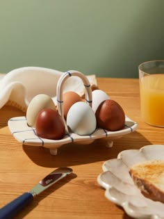 eggs and toast on a plate next to a glass of orange juice