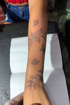 a person with a butterfly tattoo on their arm