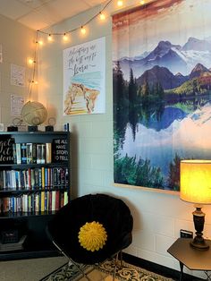 a room with bookshelves, lights and posters on the wall