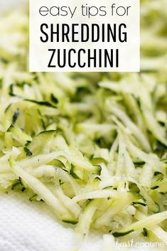 shredded zucchini on a white towel with text overlay that reads easy tips for shredding zucchini