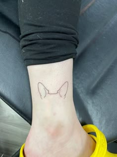 a woman's foot with a small tattoo on the side of her left leg