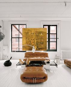 a living room filled with furniture and lots of windows in the wall next to each other