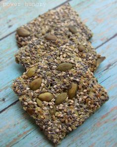 some kind of food that is on top of a wooden table and has seeds all over it